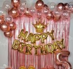 Happy birthday golden foil with rose gold curtains and balloons